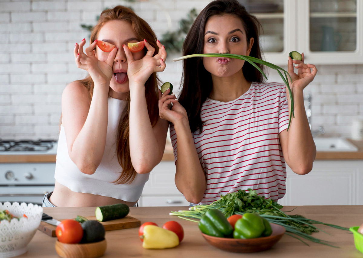 дівчата на кухні готують їжу та веселяться під час цього процесу