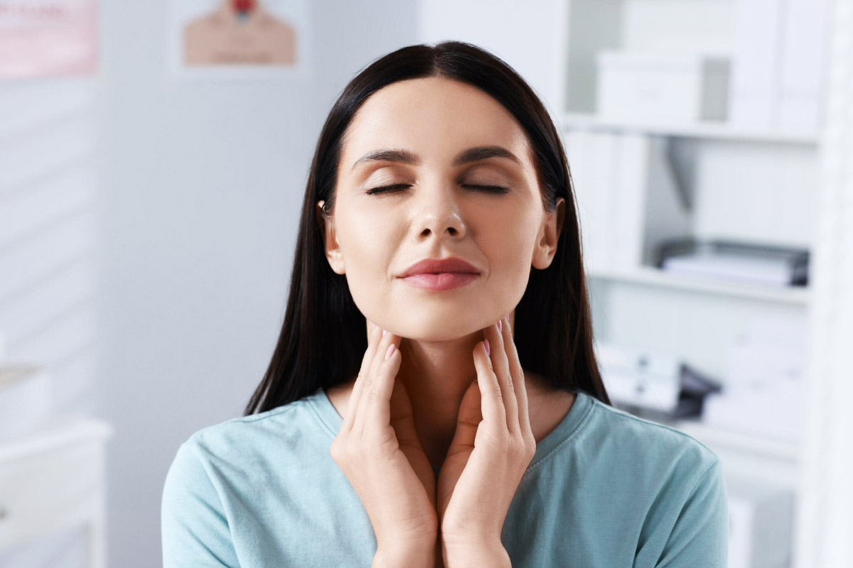 жінка проводить самостійну пальпацію своєї щитоподібної залози